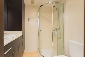 a bathroom with a shower and a toilet and a sink at Port de Xabia V in Jávea