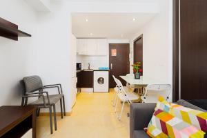 a living room and kitchen with a table and chairs at Port de Xabia V in Jávea +5 photos