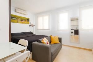 a living room with a couch and a bed at Port de Xabia V in Jávea