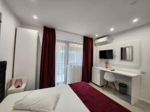 a bedroom with a bed and a desk and a window at Analeya in Eforie Nord