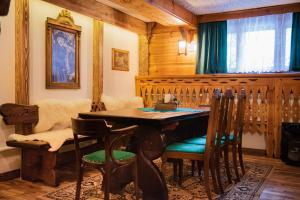Pokoje Gościnne Biały Bizon في رابكا: غرفة طعام مع طاولة وكراسي خشبية