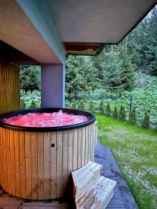 a large hot tub sitting on a patio at Prywatna Sauna i jacuzzi! Tatra Spa Witów in Witów