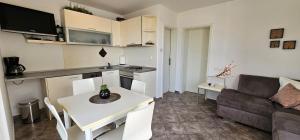 a small living room with a table and a couch at Apartman Chilli in Dramalj +6 photos