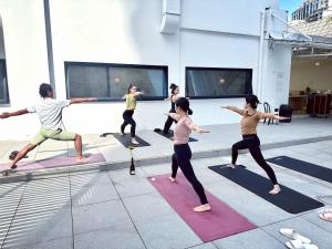 a group of people in a yoga class at Hi Cozy International Youth Hostel East Nanjing Road & The Bund - Free Coffee and Gym in Shanghai