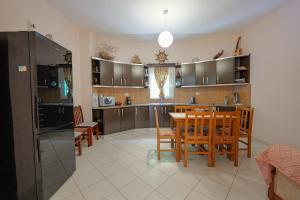 卡薩米里的住宿－Villa M Cako，厨房以及带桌椅的用餐室。