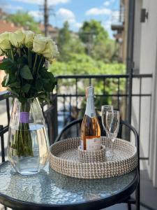 a table with a bottle of wine and a vase with flowers at Miracle Place in Ivano-Frankivsʼk