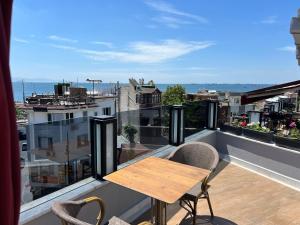 a balcony with a wooden table and chairs on a balcony at GLK PREMIER The Home Suites & Spa in Istanbul