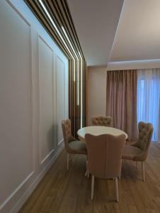 a dining room with a table and chairs at Suites In Tbilisi Hilton Apartment in Tbilisi City