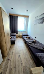 a room with two beds and a window at Zebrzydowicka 37 in Rybnik