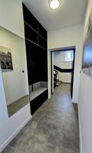 a room with a hallway with a couch and a mirror at Zebrzydowicka 37 in Rybnik