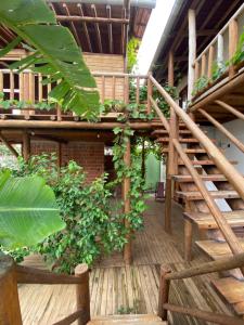 a wooden spiral staircase in a building with plants at Casa agradável com pátio in Tianguá