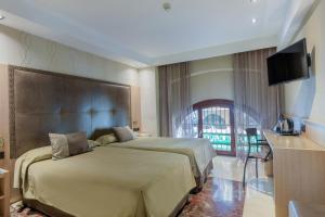 a hotel room with two beds and a flat screen tv at Hotel Gótico in Barcelona