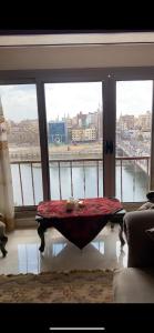 a table in a room with a view of a river at شقة فندقية مميزة بالمنصورة in Ṭalkha