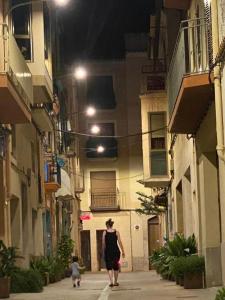 a woman walking down a street with a child at IM80 in Montroig