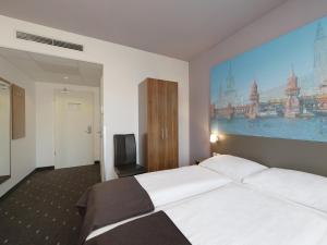 Postel nebo postele na pokoji v ubytování B&B Hotel Berlin City-Ost