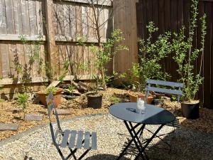 une table et des chaises dans un jardin avec une clôture dans l'établissement Alderbury Studio, à Salisbury