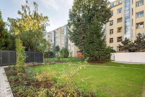 a garden in front of a building at Stylish Studio near Dejvická metro station in Prague