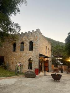 a large stone building with a large bowl in front of it at Apart-hotel Cantinho da Serra in Nova Friburgo