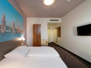Postel nebo postele na pokoji v ubytování B&B Hotel Berlin City-Ost