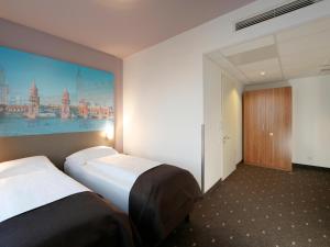 Postel nebo postele na pokoji v ubytování B&B Hotel Berlin City-Ost