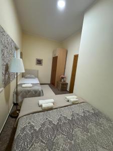 a bedroom with two beds with towels on them at Apartment OLIVA1 in Petrovac na Moru