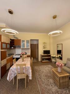 a living room with a table and a kitchen at Apartment OLIVA1 in Petrovac na Moru