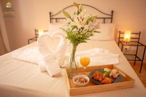 a tray with a vase of flowers and a plate of food at Apartement Zen&Chill Don Franco in Adeje +33 photos