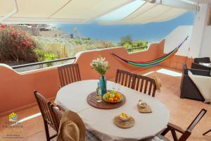 a table with a bowl of fruit on a balcony at Apartement Zen&Chill Don Franco in Adeje