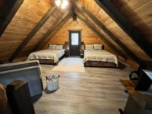 a room with two beds in a attic at Sage Hill Cabin in Londonderry