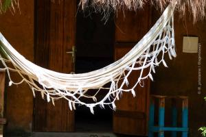 a hammock hanging from a door of a building at Pousada Roy Bonete in Ilhabela