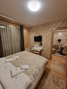 - une chambre avec un grand lit et un miroir dans l'établissement Desetka10 Zlatibor, à Zlatibor