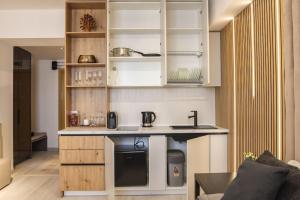 a kitchen with white cabinets and a sink at Lagoon Studio 705 in Bucharest