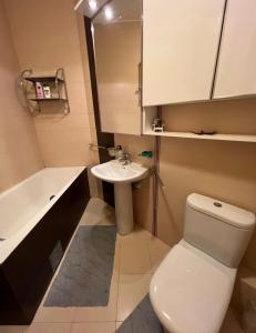 a bathroom with a white toilet and a sink at Bar Luxury Apartment in Bar +11 photos