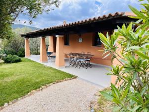a patio of a house with a table and chairs at Casagliana Suite Resort in Olbia