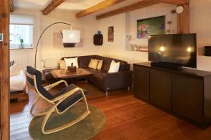 ein Wohnzimmer mit einem Sofa und einem Flachbild-TV in der Unterkunft Ferienparadies Grube in Grube