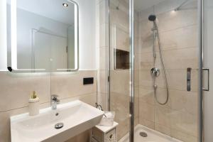 a bathroom with a sink and a shower at Meerliebe in Westerland (Sylt) +16 photos