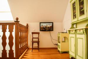 a living room with a tv on the wall at Dom gościnny w Bartniku in StrÃ³Å¼e