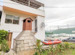 a house with a red kayak in front of it at Holiday Home Riva in Ston