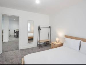 a bedroom with a bed and a mirror and a table at Apartment 1 in Loftus by Belvilla in Loftus