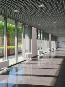 a large empty room with windows in a building at BIG 21 Old Town LUX Apartment, self check-in 24h, free parking in Poznań