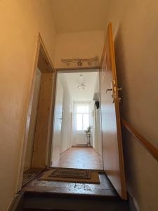 a hallway with a door leading into a room at Helles Apartment in Quedlinburg