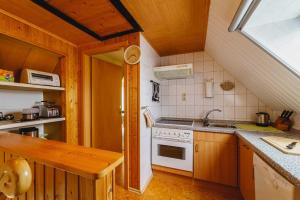 a small kitchen with a sink and a stove at Ferienwohnungen im Deichweg in Zingst