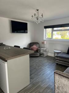 a living room with a counter top and a living room at Willow Lodge in Dymchurch +19 photos