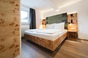 A bed or beds in a room at Genusshotel Fichtenhof