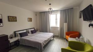 a bedroom with a bed and a chair and a window at LOFT HOUSE in Skhidnitsa +69 photos