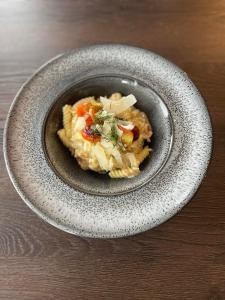 a bowl of pasta with vegetables on a table at Manor House Hotel in Thurso