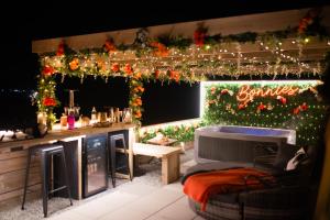 a patio with christmas lights and a bar in a room at Tan Y Bryn Glamping in Conwy