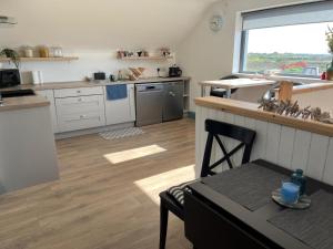 a kitchen with a counter and a table in a room at Riverfield Apartment in Milltown Malbay