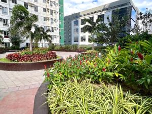 a garden with flowers and plants in front of buildings at IT Park + fast net in Cebu City