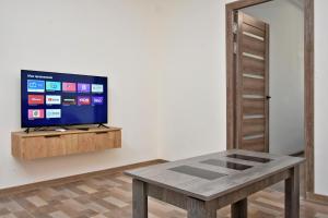 a living room with a table and a tv at EvnAir in Pʼarakʼar
